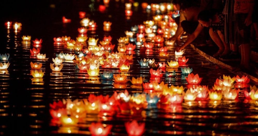 Floodwaters reflect glowing lanterns in the ancient town of Hoi An during a seasonal downpour